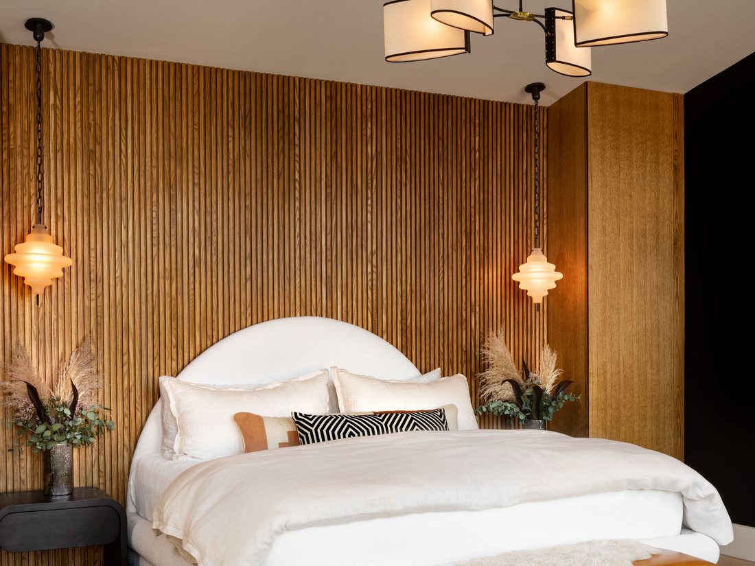 Bedroom accent wall covered in a warm grasscloth-look wallcovering